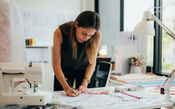 istock Beautiful woman dressmaker working in workshop studio 1474111030
