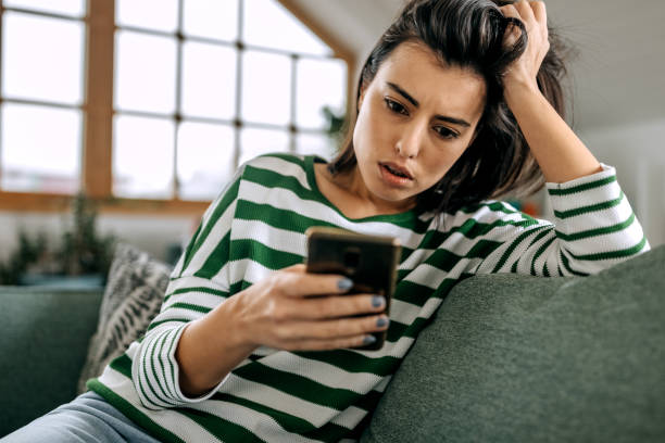 istock Worried young woman using mobile phone 1474112627