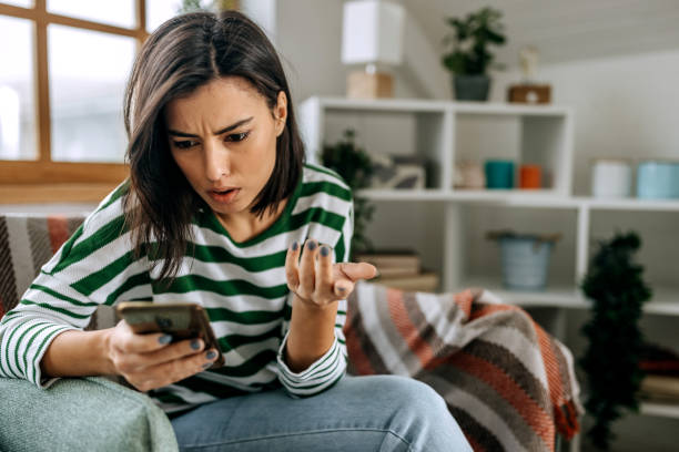 istock Worried young woman using mobile phone 1474112653