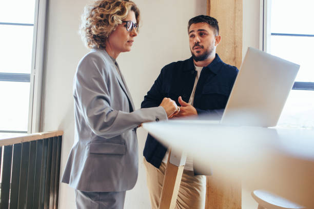 istock Two business people talking to each other about a project in an office 1474114354