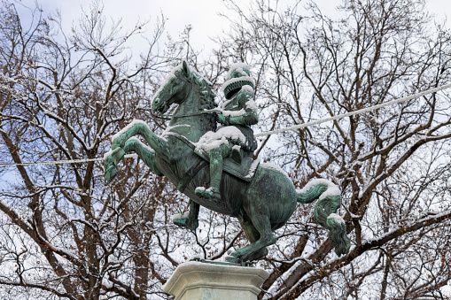 Innsbruck, Austria - February 26, 2023: Equestrian statue of Archduke Leopold V on Rennweg street. Figure is covered with snow