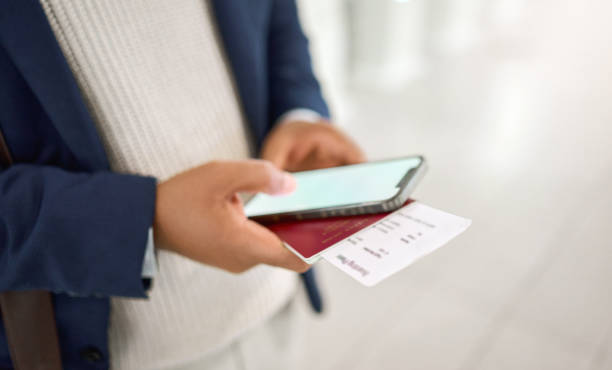 istock Hands, phone and passport chatting, typing or texting on mobile app or checking flight times at the airport. Hand of business employee holding smartphone and ID documents for travel, trip or journey 1474115537