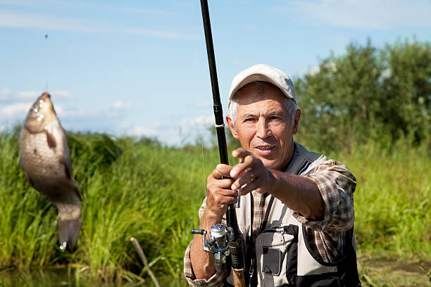 istock Fisherman catches of crucian 147411616