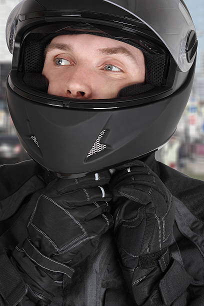 istock young motorcyclist man wearing helmet 147411819