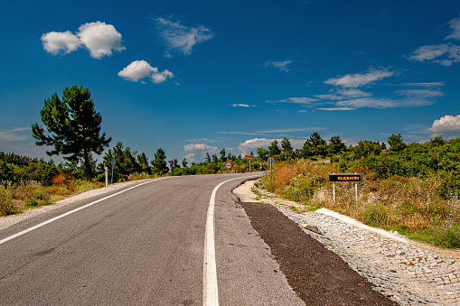 Asphalt highway and mountain with blue sea natural landscape.