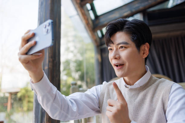 istock Young businessmen use mobile phone video conferencing in restaurants 1474118887