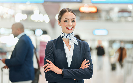 Airport, woman concierge and portrait with smile, arms crossed and vision for career in international travel. Customer service, transport service expert and happy for job with motivation at workplace