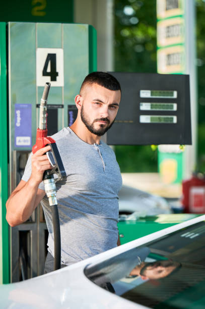 istock Skilled driver refueling his automobile for long road. 1474119768