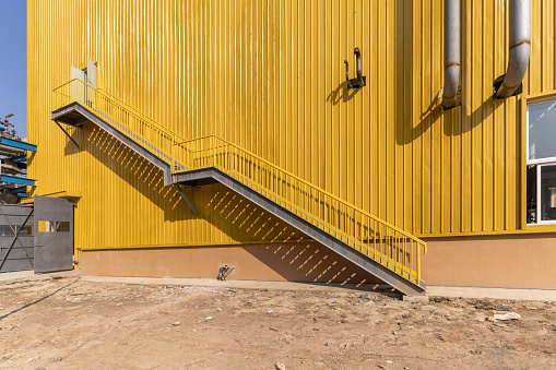 Yellow factory building and equipped stairs