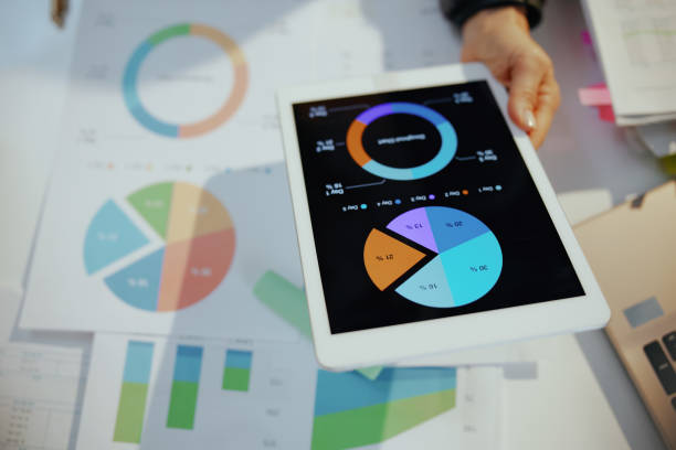 istock business woman with tablet pc working with documents and graphs 1474120397