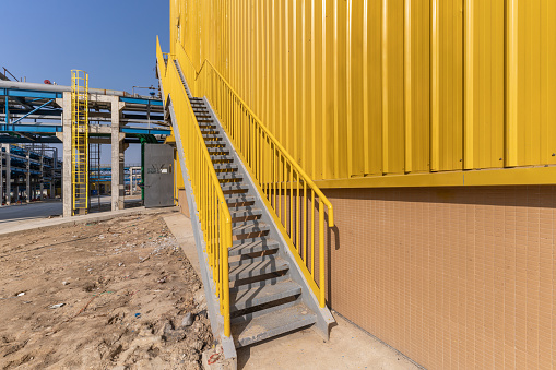 Yellow factory building and climbing stairs