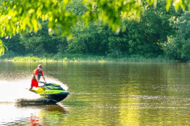 istock A jet ski racer drives water transport on a river at sunset. 1474121521