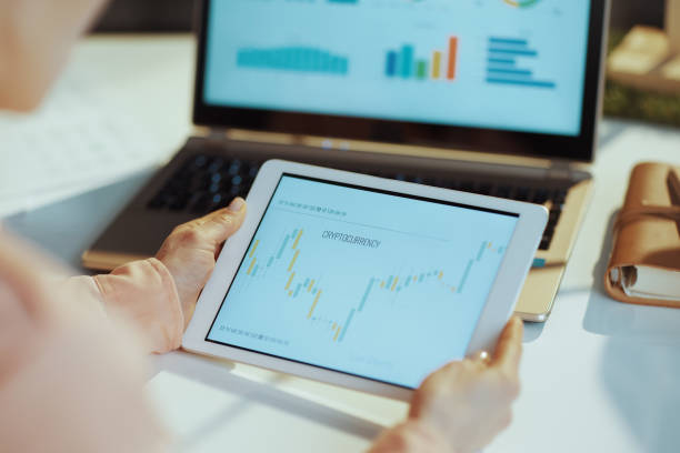 istock woman using tablet PC and analysing stock market 1474124177
