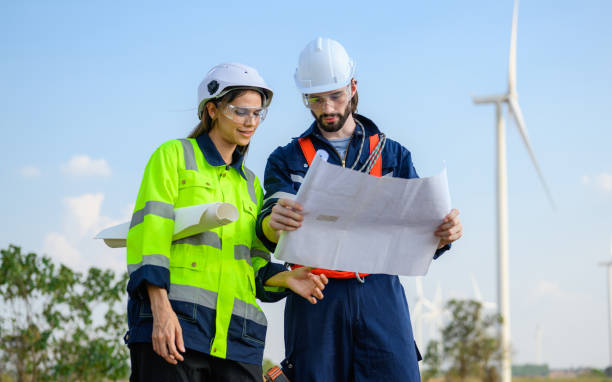 istock Professional engineer technician working outdoor at wind turbine field 1474124336