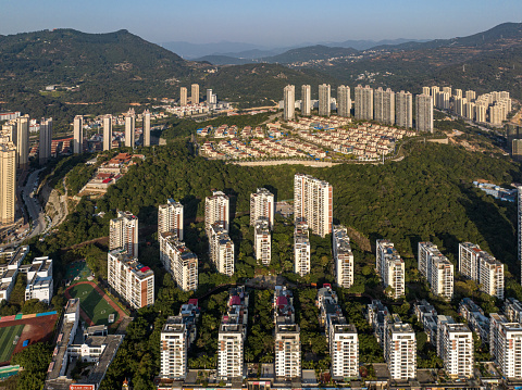 Livable urban buildings are surrounded by woodland and river