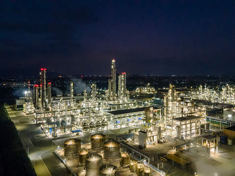 Aerial view of lighting chemical plant equipment and buildings at night