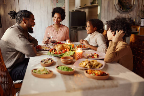 istock Happy black family talking during lunch in dining room. 1474127732