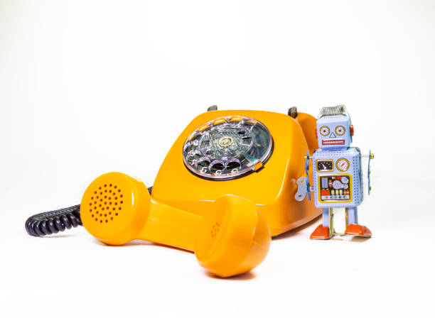 istock Old orange telephon with toy robot 1474127953