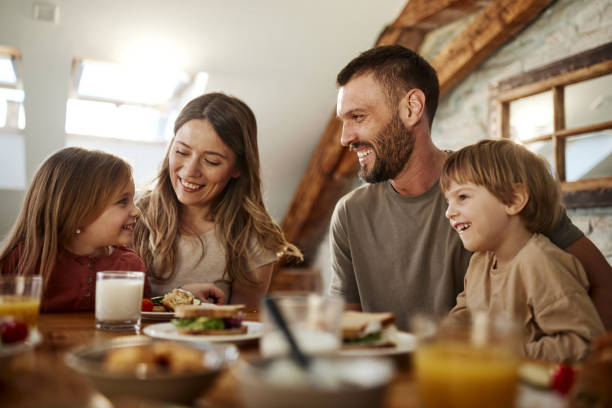 istock Young family talking during breakfast at dining table. 1474130473