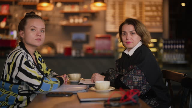 Portrait of two businesswomen in cafe