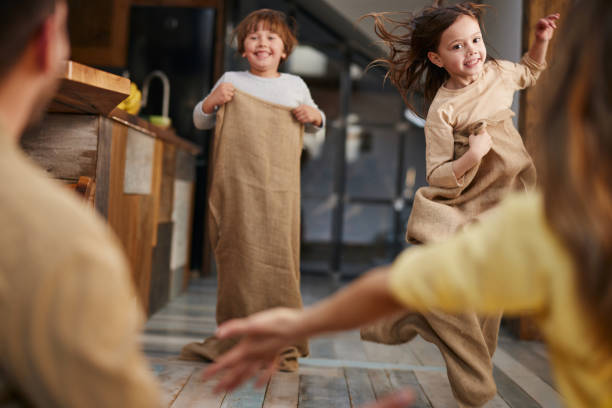 corrida de saco em casa! - child playing sack race sports race - fotografias e filmes do acervo