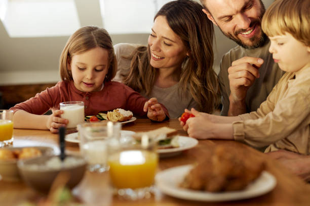 istock Happy family enjoying during breakfast at dining table. 1474130922