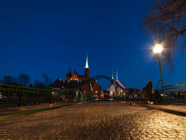 night view on cobblestone bridge, way to the old city district