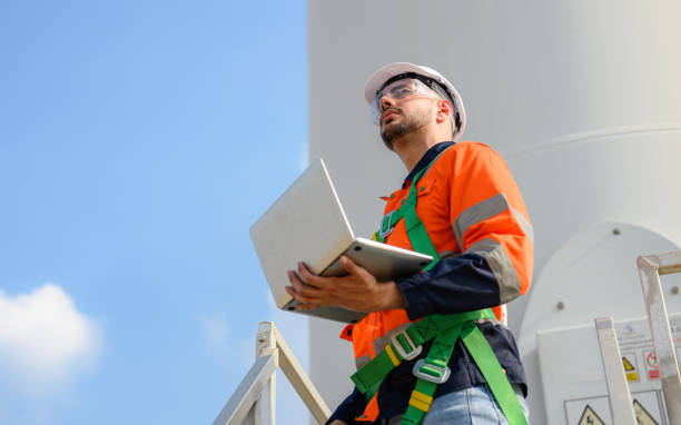 istock Professional engineer technician team working at wind turbine farm field 1474131892