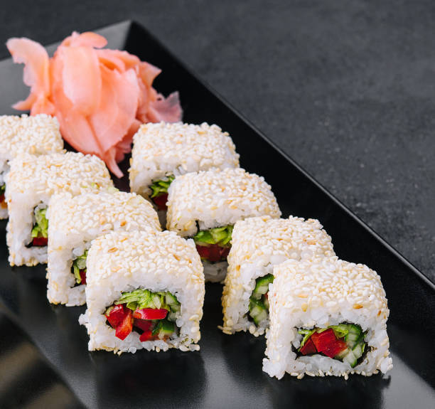 istock vegetarian sushi maki rolls with sesame seeds on black plate 1474131974
