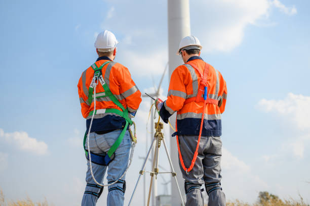 istock Professional engineer technician team working at wind turbine farm field 1474132202