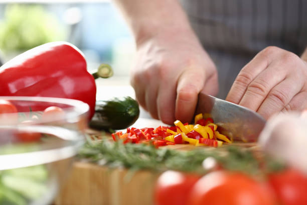istock Cook cuts avegetable salad from fresh vegetables 1474132273