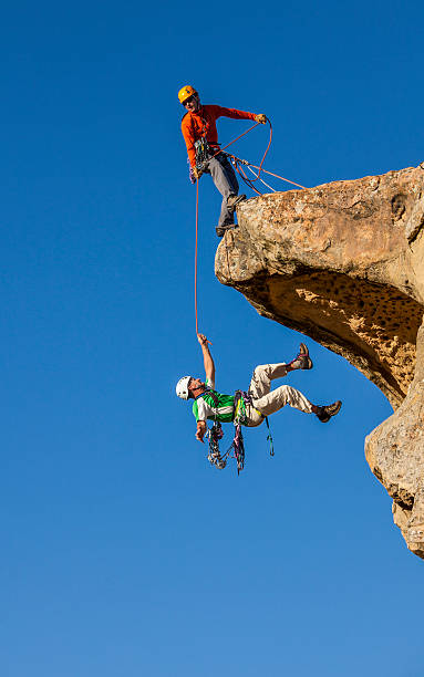 Falling climber saved by his partner. stock photo