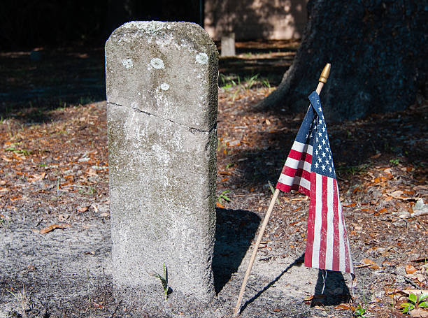 istock Nameless Headstone and Grave with American Flag 147413442