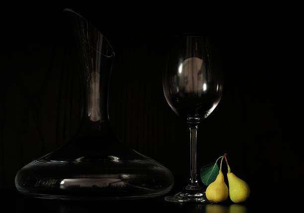 elegant decanter with glass and small pears stock photo