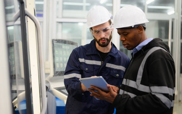 istock Technician engineer team checking and repairing part of automatic machine 1474136213