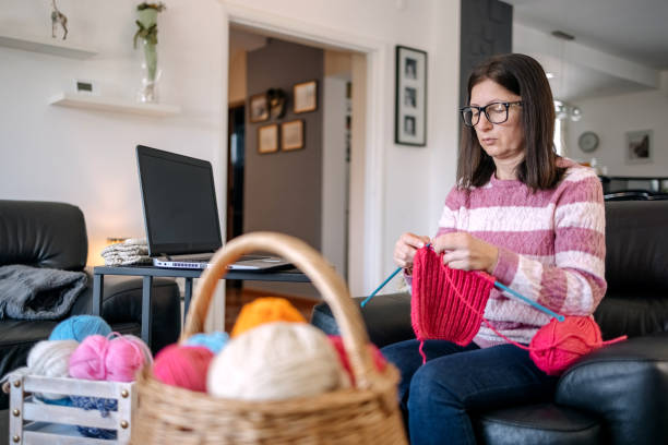 istock Knitting at home in living room 1474136241