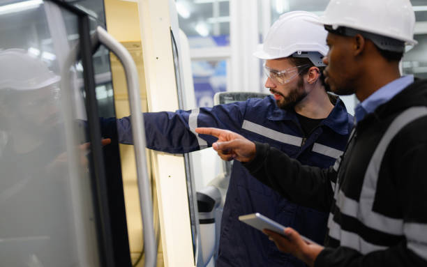 istock Technician engineer team checking and repairing part of automatic machine 1474136351