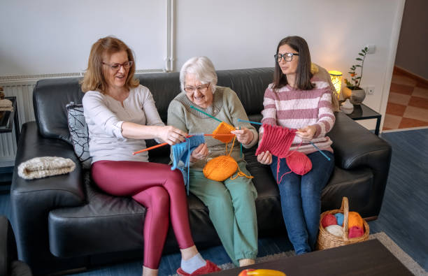 istock Senior woman teaching her daughters how to knit 1474136480