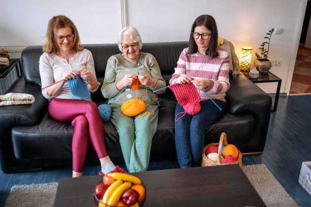 istock Senior woman teaching her daughters how to knit 1474136483