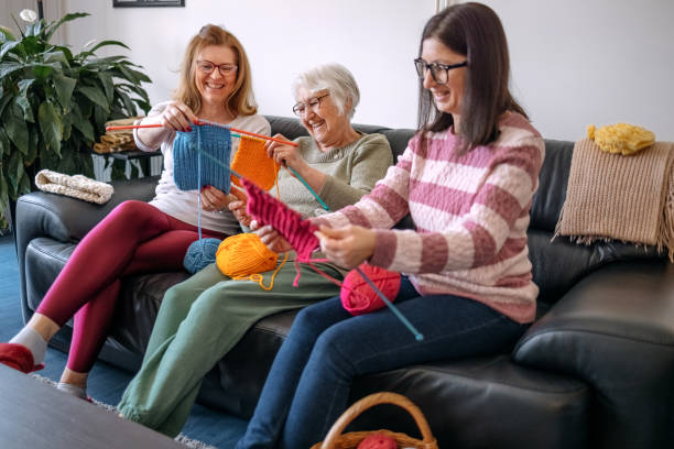 istock Senior woman teaching her daughters how to knit 1474136488