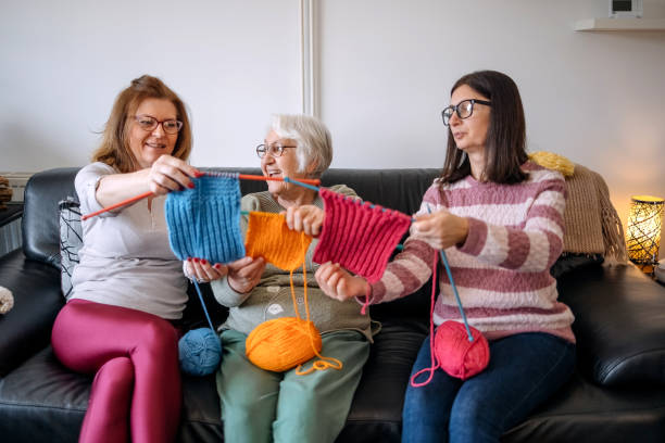 istock Senior woman teaching her daughters how to knit 1474136489