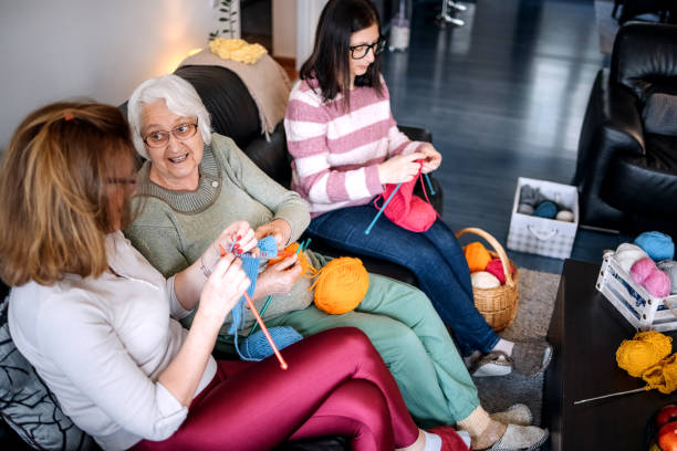 istock Senior woman teaching her daughters how to knit 1474136541