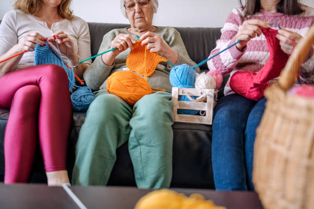istock Senior woman teaching her daughters how to knit 1474136587