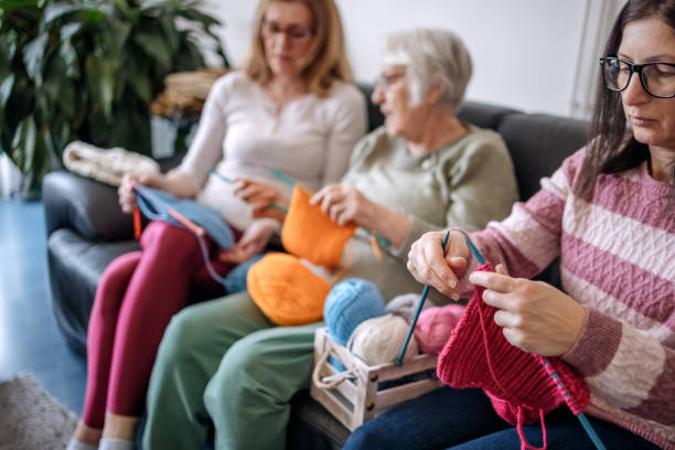 istock Senior woman teaching her daughters how to knit 1474136599
