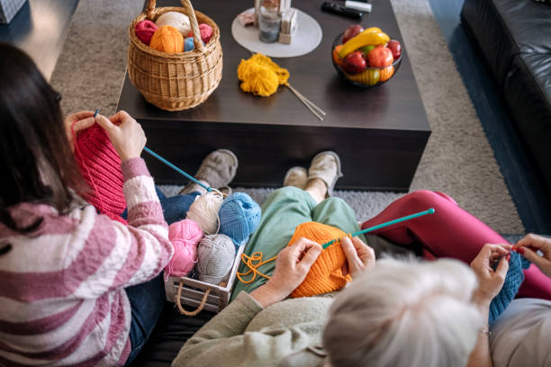 istock Senior woman teaching her daughters how to knit 1474136603