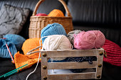 istock Knitting at home in living room 1474136805