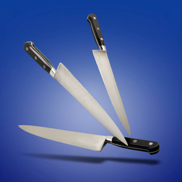 istock Floating close up of well used knifes on blue gradient 1474140628