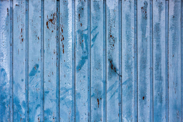 Blue and White Weathered Metal Garage Door with Rust Spots: Grunge and Vintage Texture Background stock photo