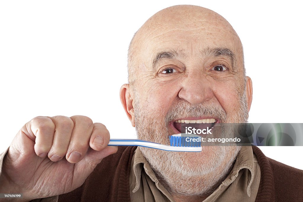 senior brushing teeth senior man brushing teeth Brushing Teeth Stock Photo