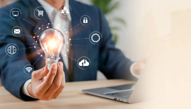 istock Businessman holding creative light bulb with digital marketing icon. Strategy analysis and planning business marketing. 1474146922